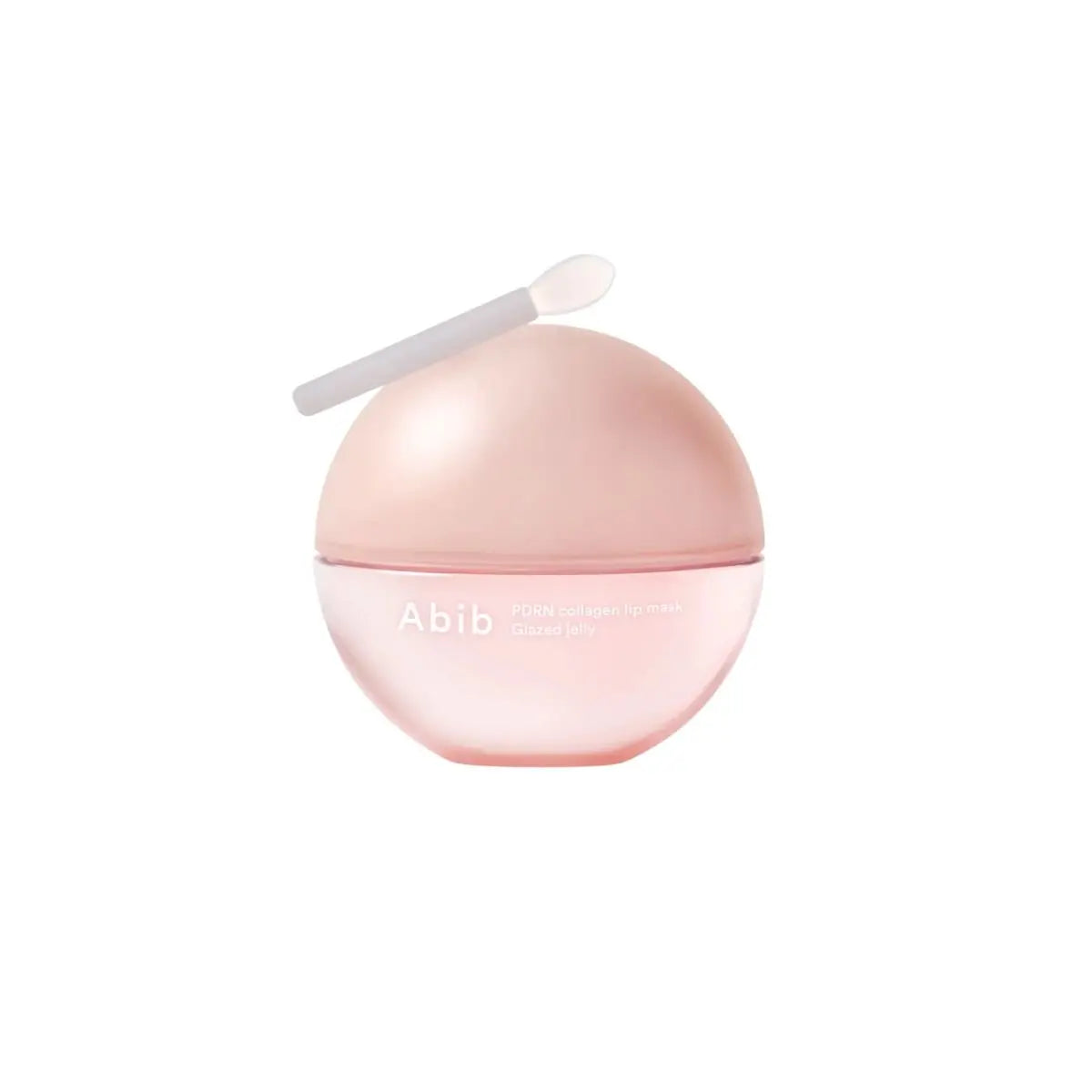 Baume à lèvres rosé en pot rond avec spatule blanche.